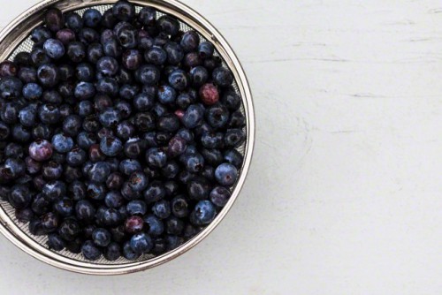 Sieve full of fresh blueberries, high angle